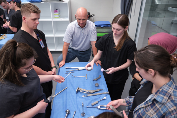 Seth Brown shows students different surgical instruments. 