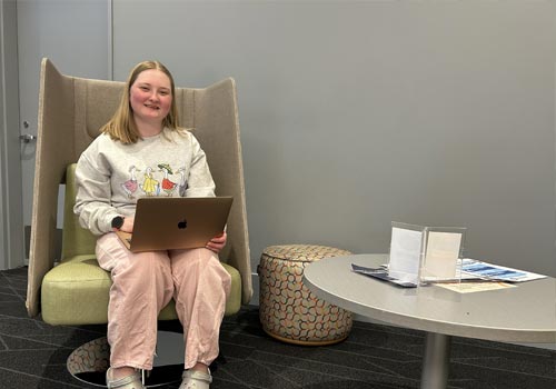 Lexis Bruns-Morris sits in a chair in a study area at SCC Lincoln Campus Center