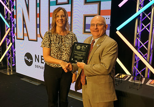 Elizabeth Tegtmeier (left), president of the Nebraska State Board of Education, presents Dr. Joel Michaelis, SCC vice president of instruction, with the Nebraska Career and Technical Education Outstanding Postsecondary Institution Award on Tuesday, June 10, in Kearney.