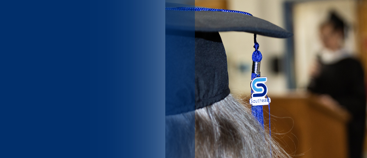 An SCC tassel is hanging off a black mortar board at SCC's prison education graduation ceremony. 