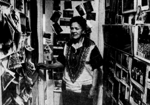 Merlyn Anderson stands in her home in a black and white photo. 