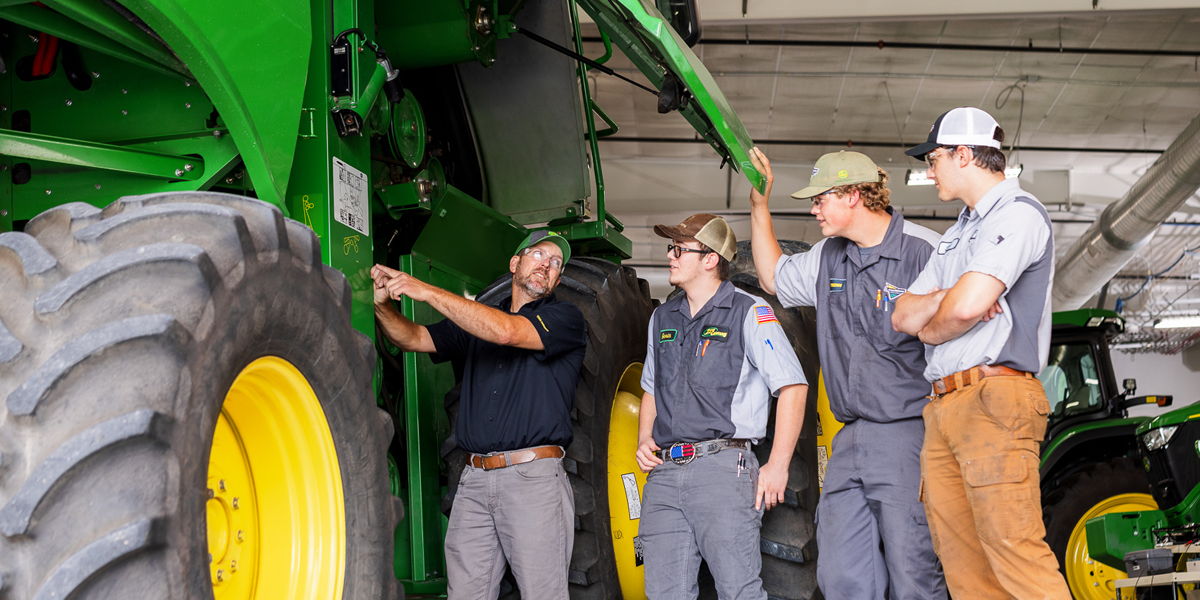 Instructor and students work on a  John Deere 